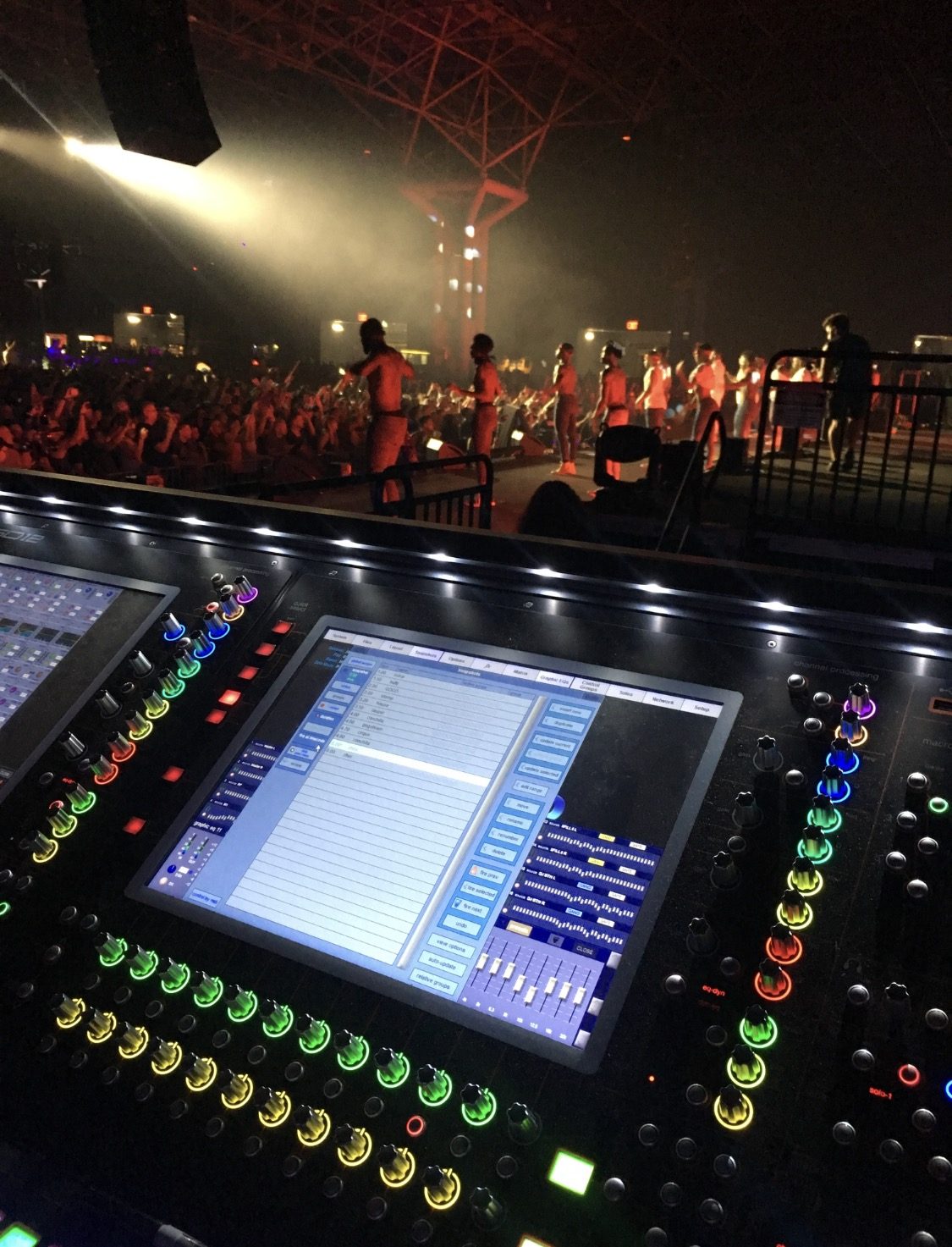Front-of-house digital mixing console at an outdoor festival