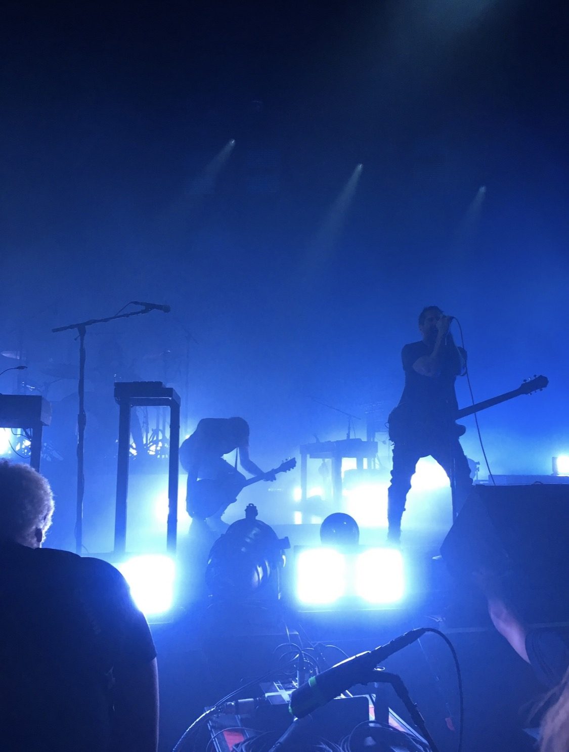 Band performing under blue stage lights