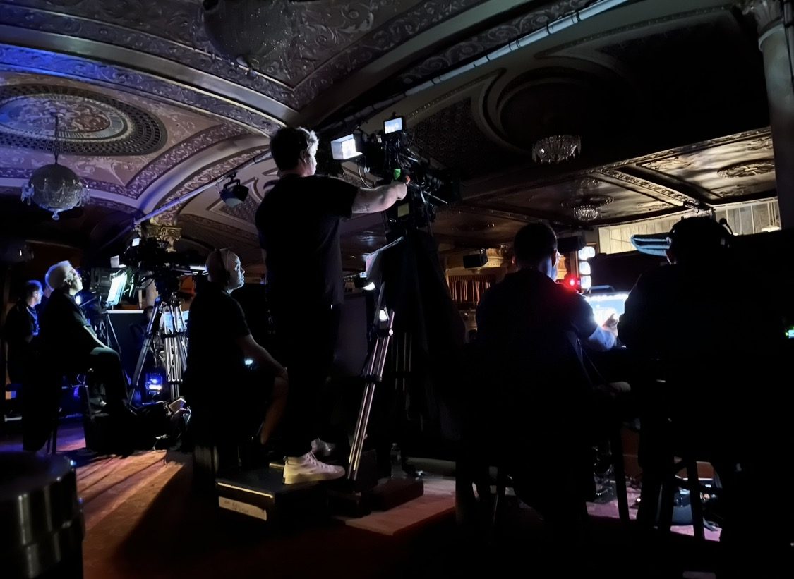 Camera crew working in an ornate theater